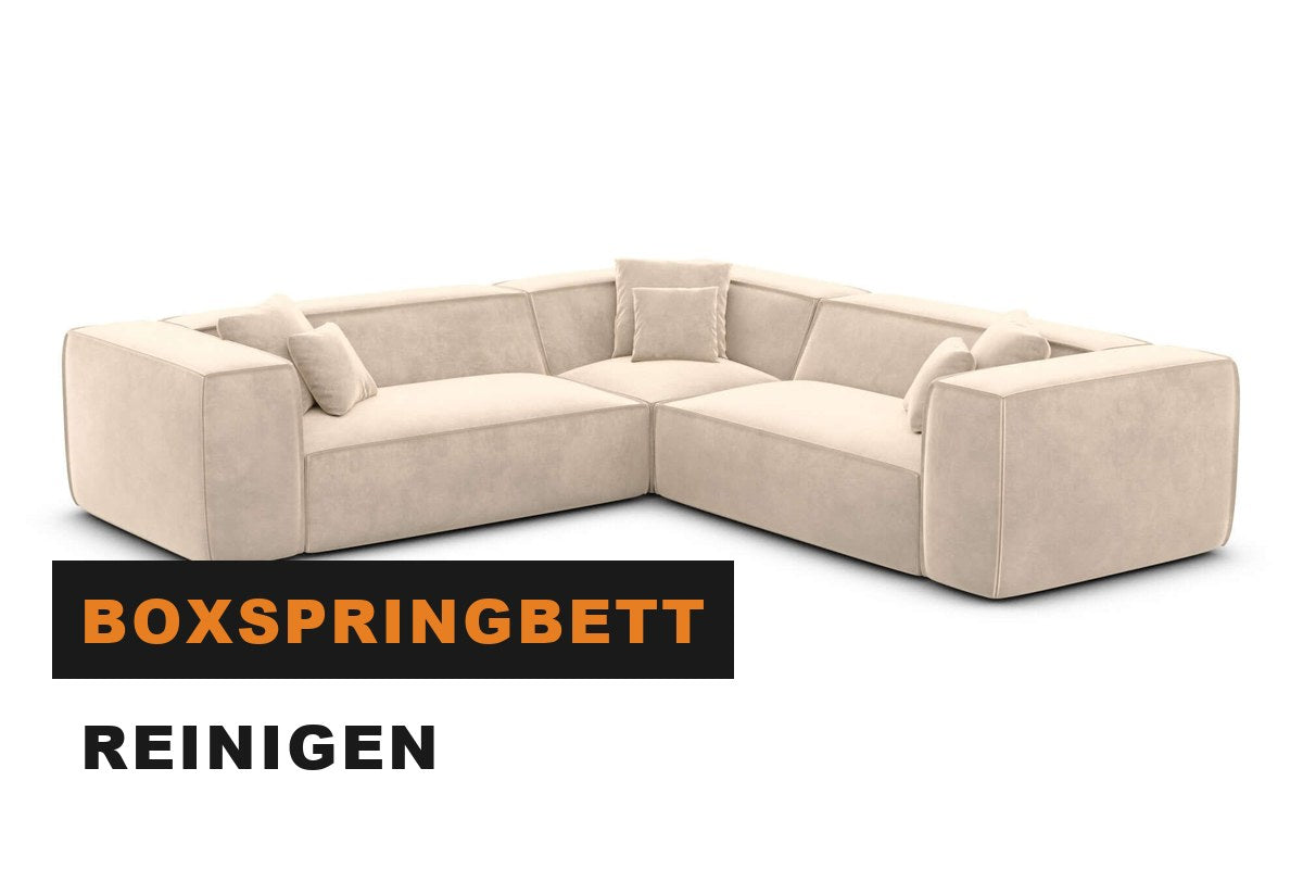 Frisch bezogenes Boxspringbett in einem hellen Schlafzimmer
