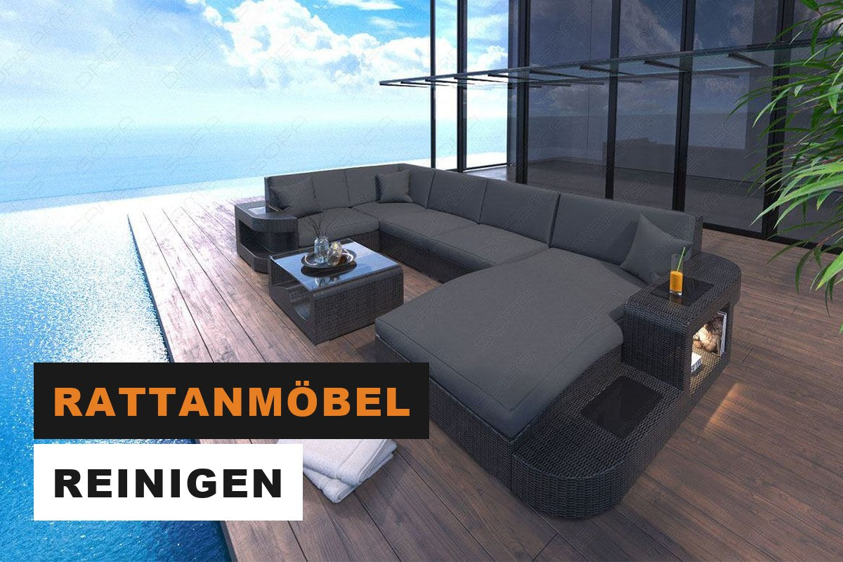 Graues Polyrattan-Gartensofa in U-Form auf einer gepflegten Terrasse